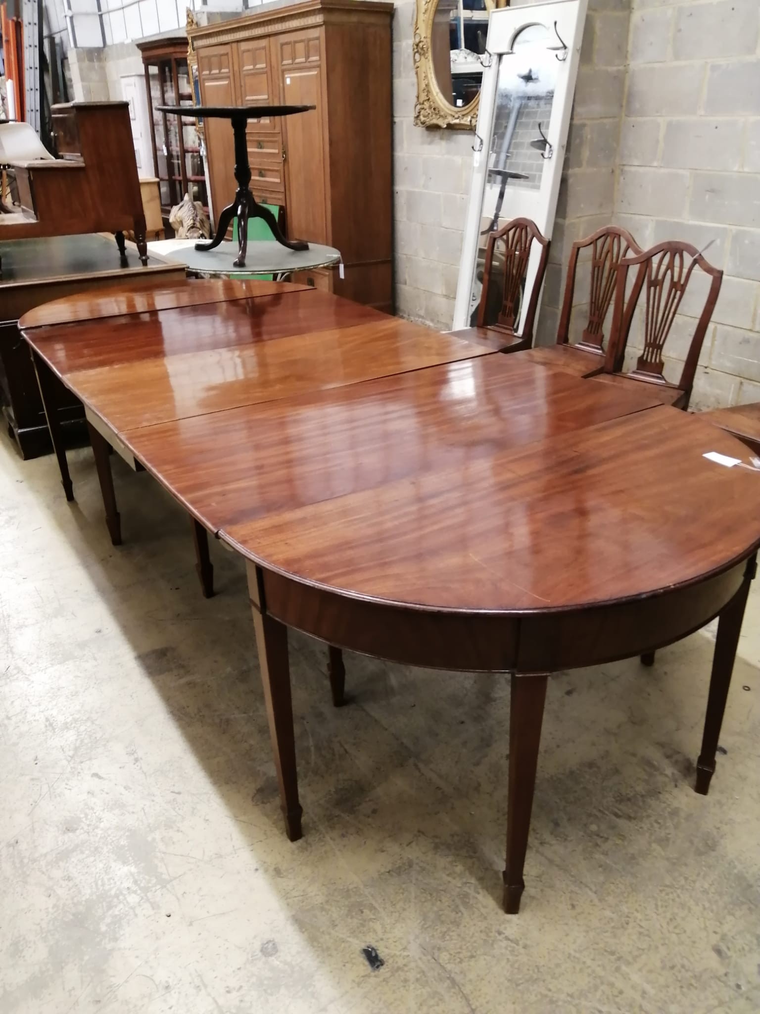 A George III mahogany D end extending dining table 304cm extended, two spare leaves, depth 122cm, height 74cm